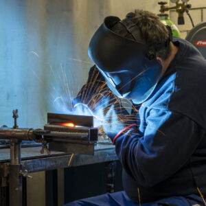 a man welding a piece of metal