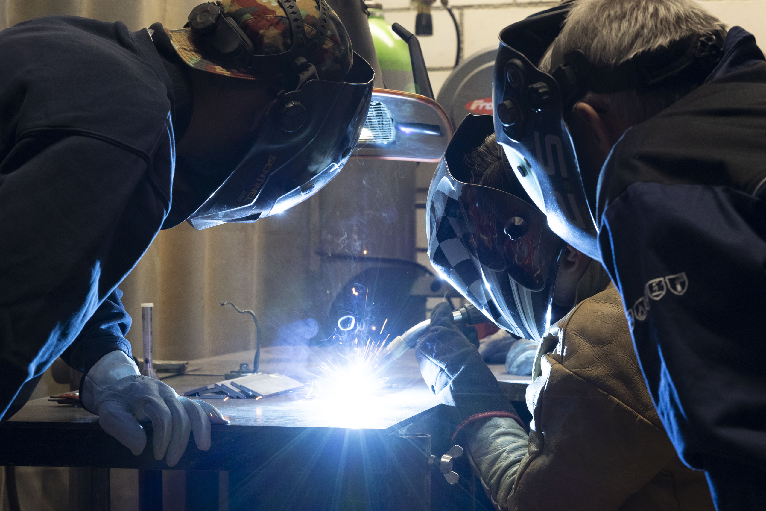 a group of people welding