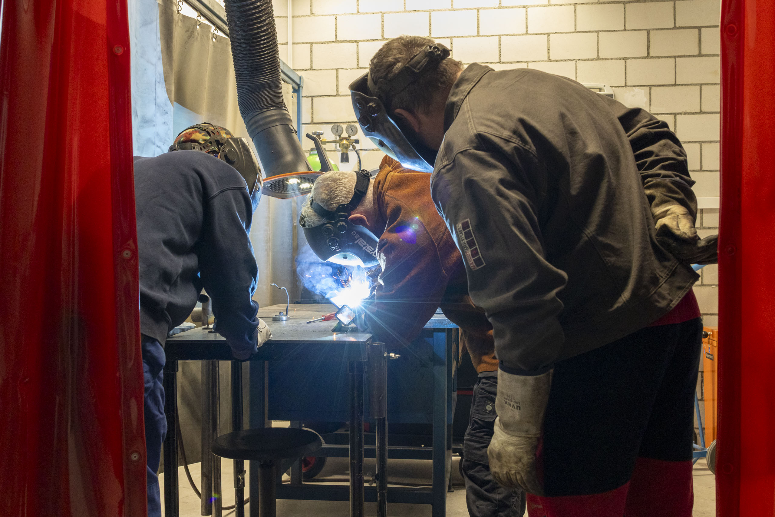 a group of people welding